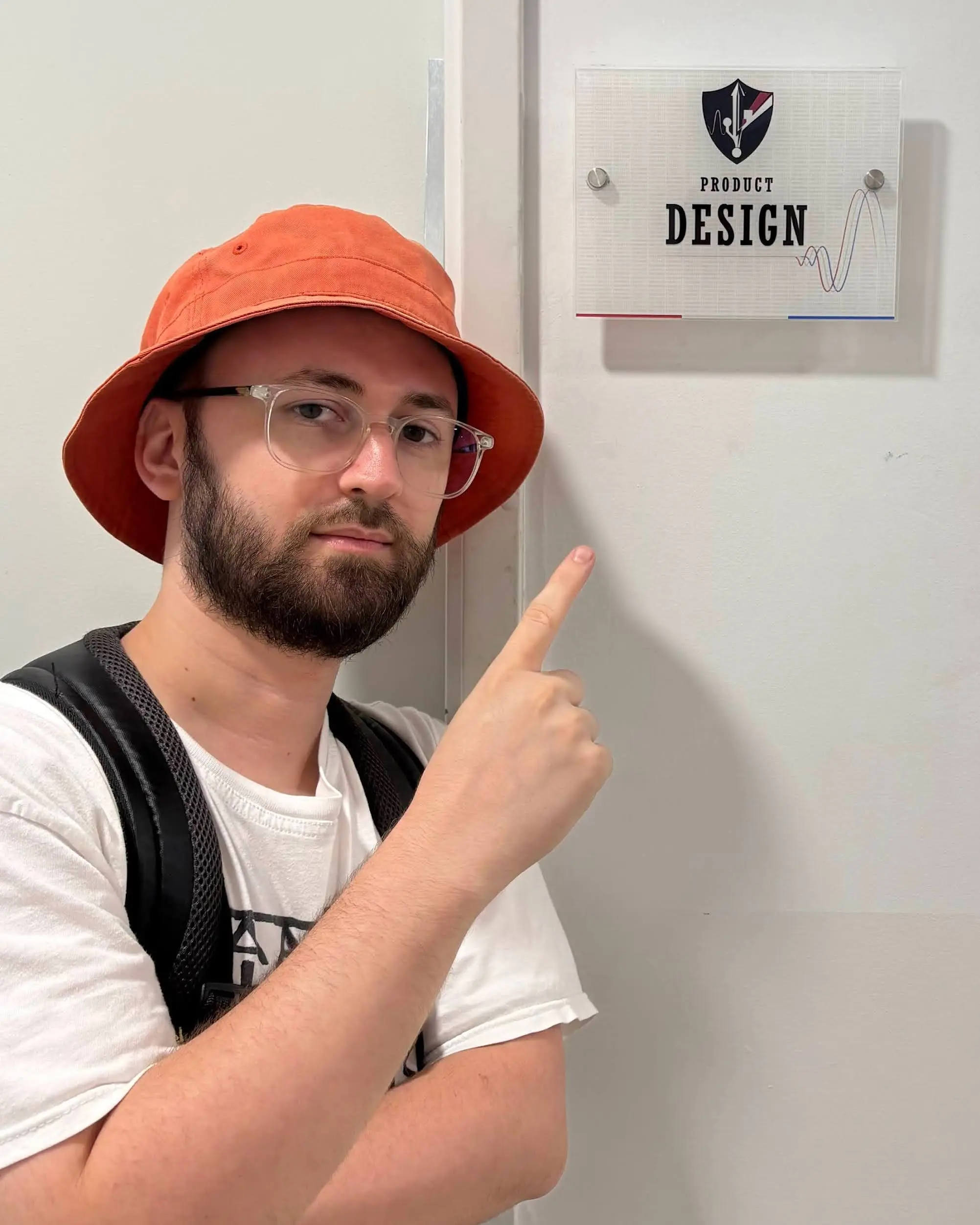 Me pointing at the Product Design office sign